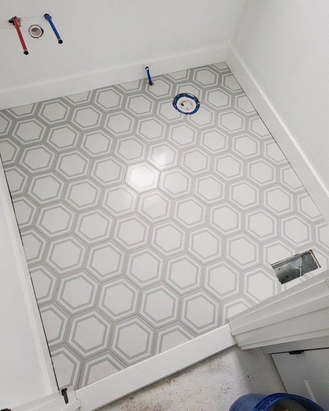 Picture of hexagon mosaic tile floors getting installed in a bathroom in Asbury Park NJ